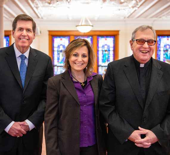 A woman sitting on a stool next to a podium